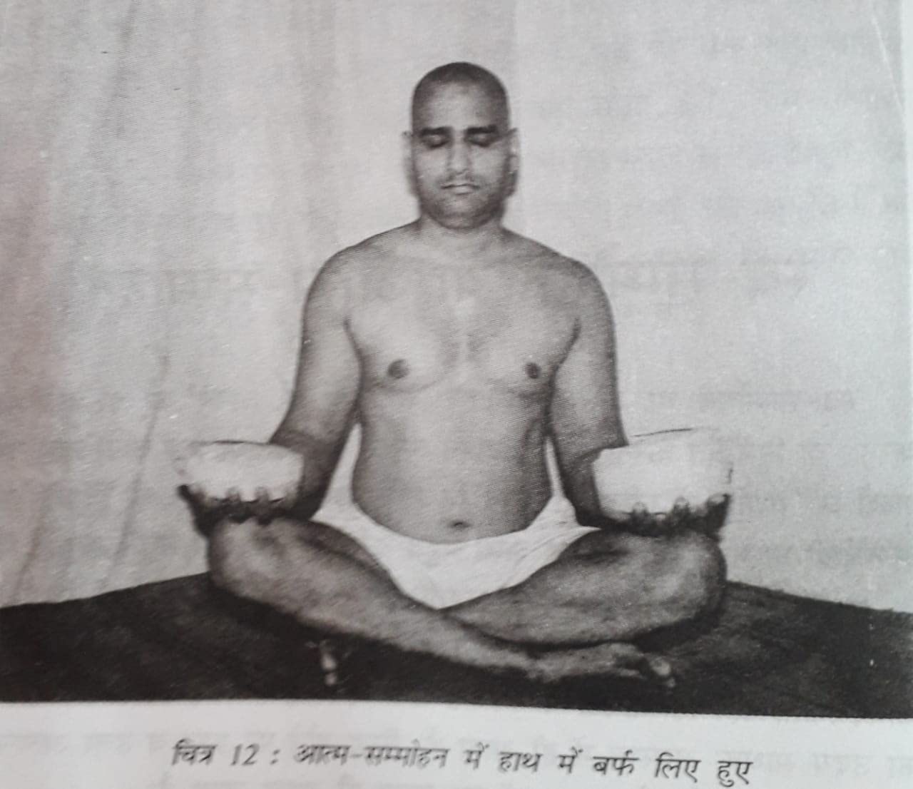 Man practicing self-hypnosis in a cross-legged position, holding bowls of ice, as depicted in 'Sammohan Se Yog Nidra Ek Vigyan'.